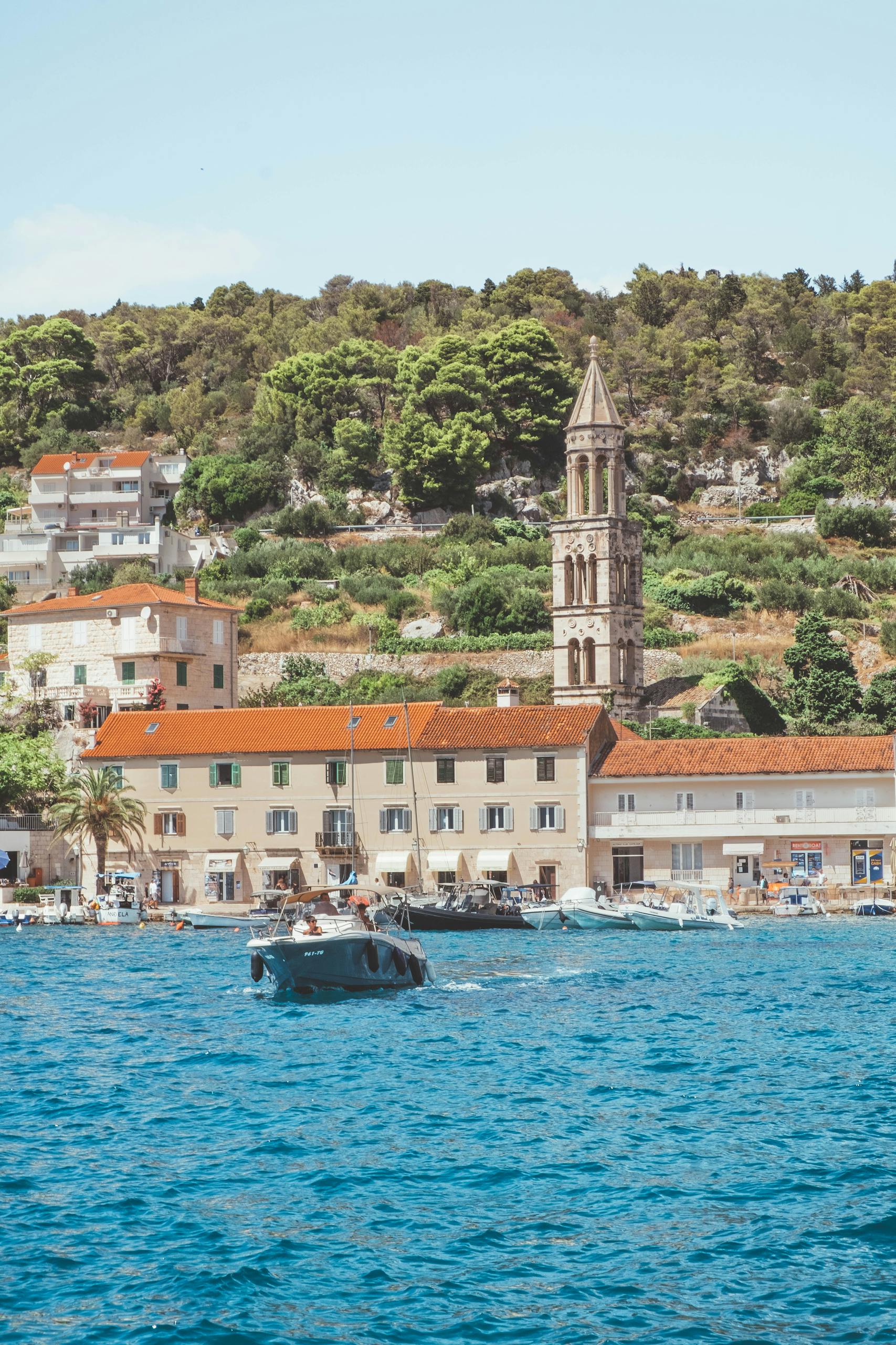 A picturesque view of Hvar harbor showcasing historic architecture and a serene waterfront.