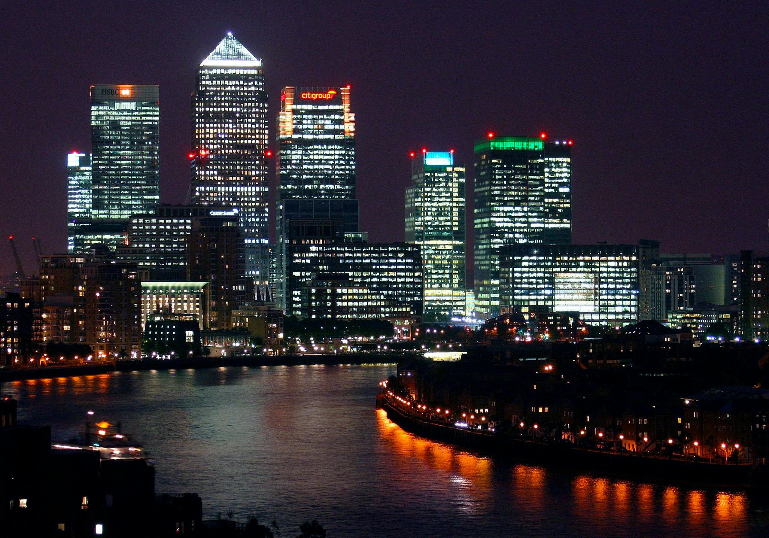 Beautiful nighttime view of Canary Wharf, London, with reflections on the River Thames.