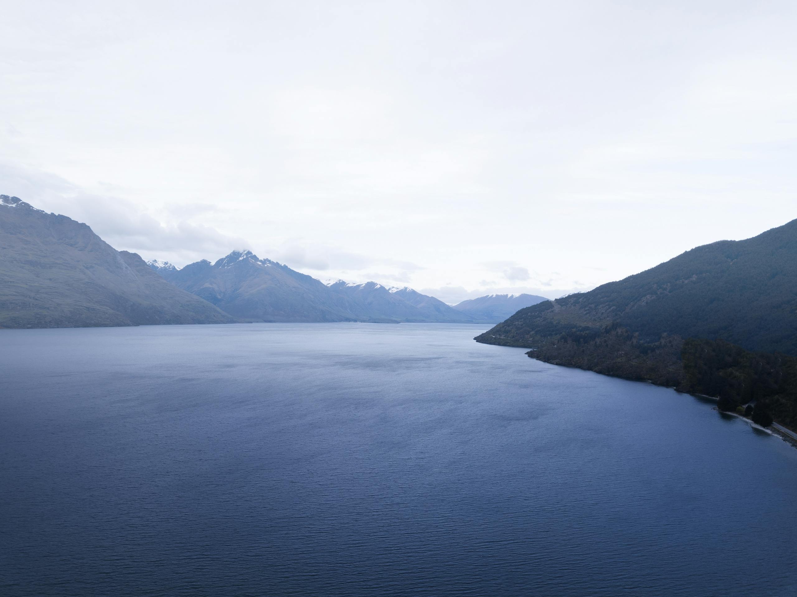 Stunning aerial view of Lake Wakatipu and surrounding mountains in Queenstown, New Zealand.