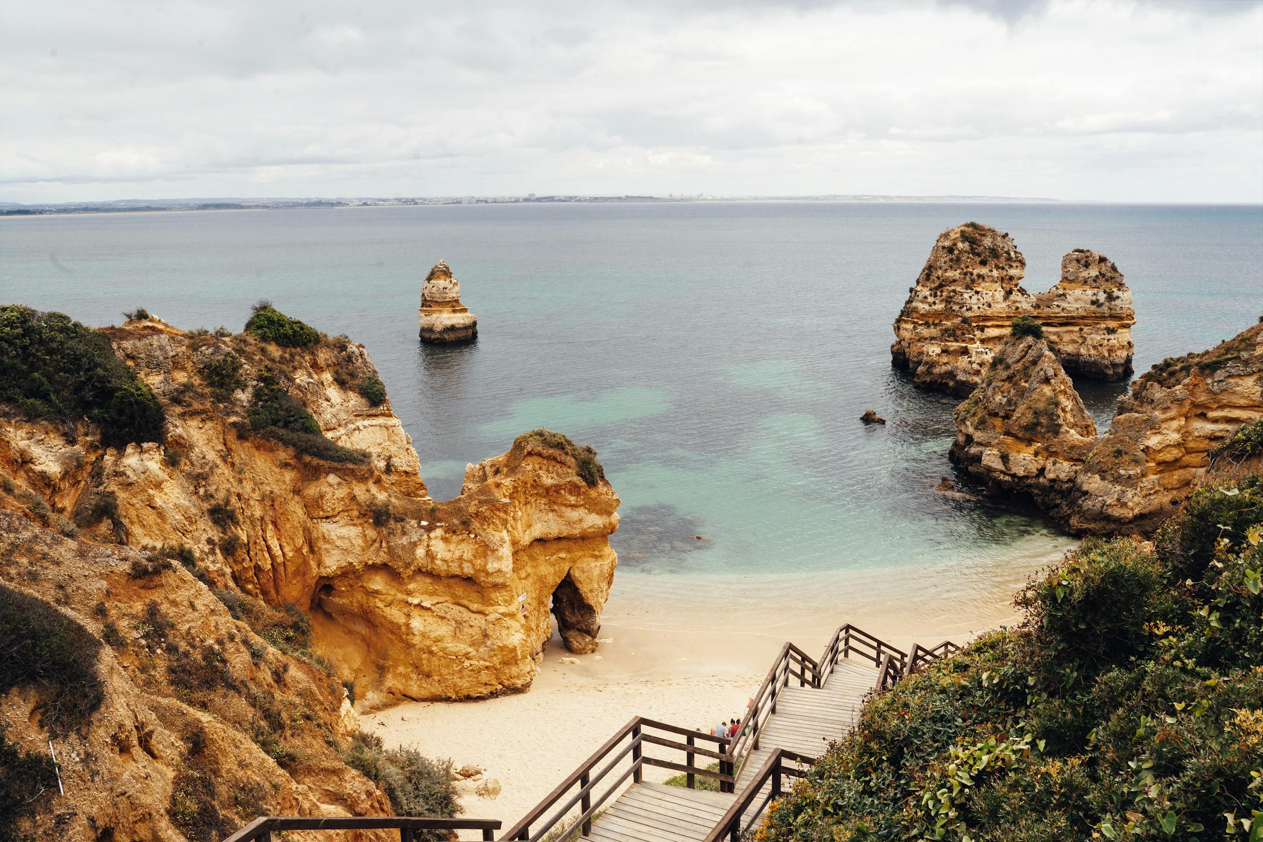 Stunning coastal landscape in Algarve with natural rock formations and clear ocean waters.