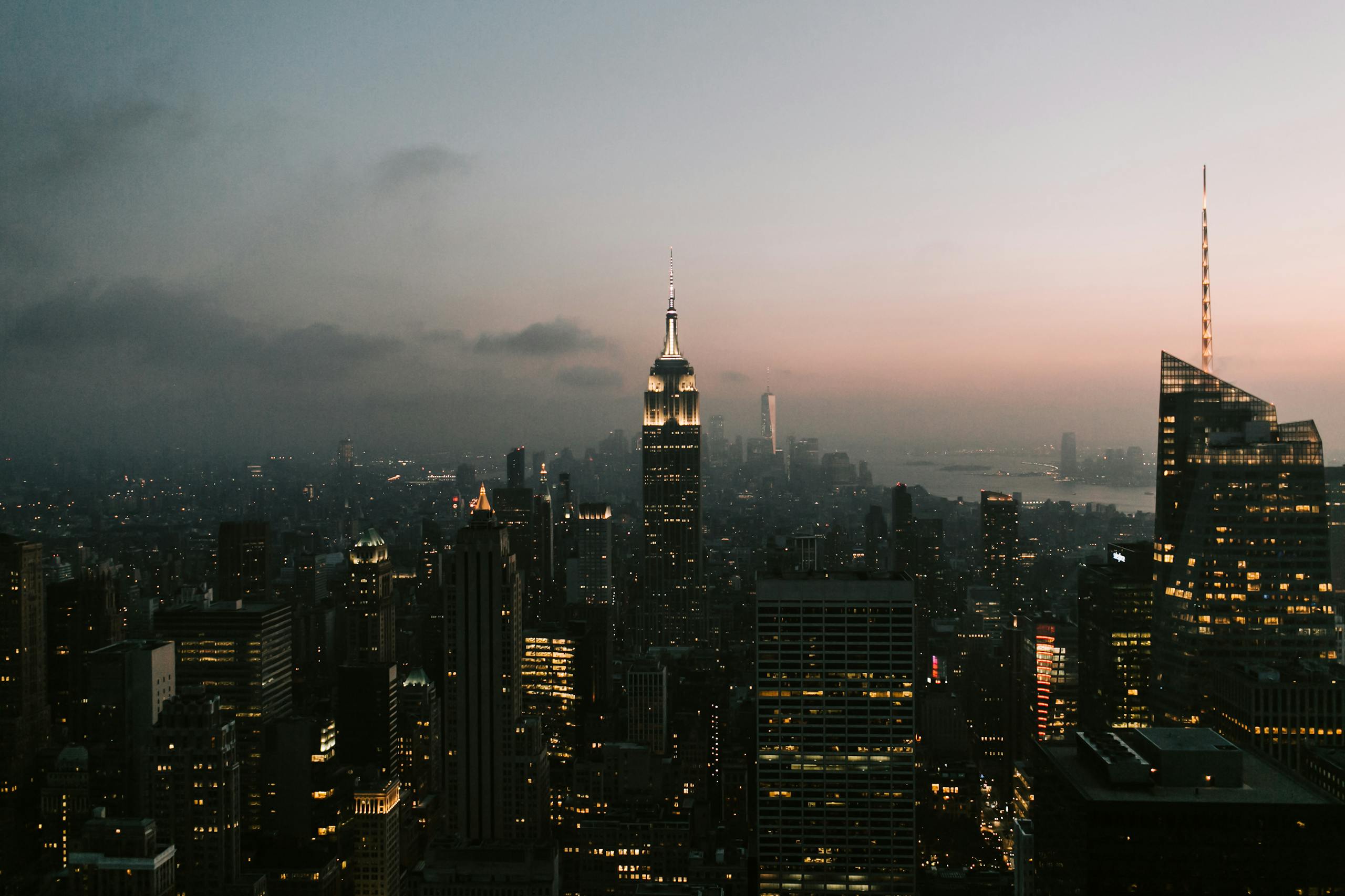 Twilight view of New York City skyline featuring the iconic Empire State Building.