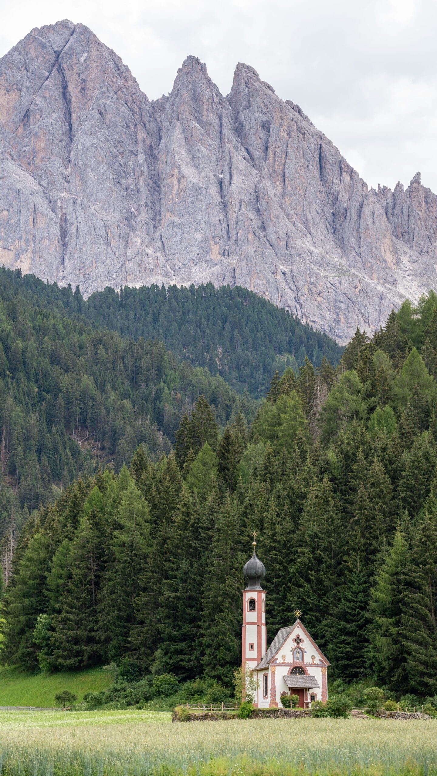 Church of St. John in Ranui with the Odle peaks behind it, Val di Funes, Dolomites