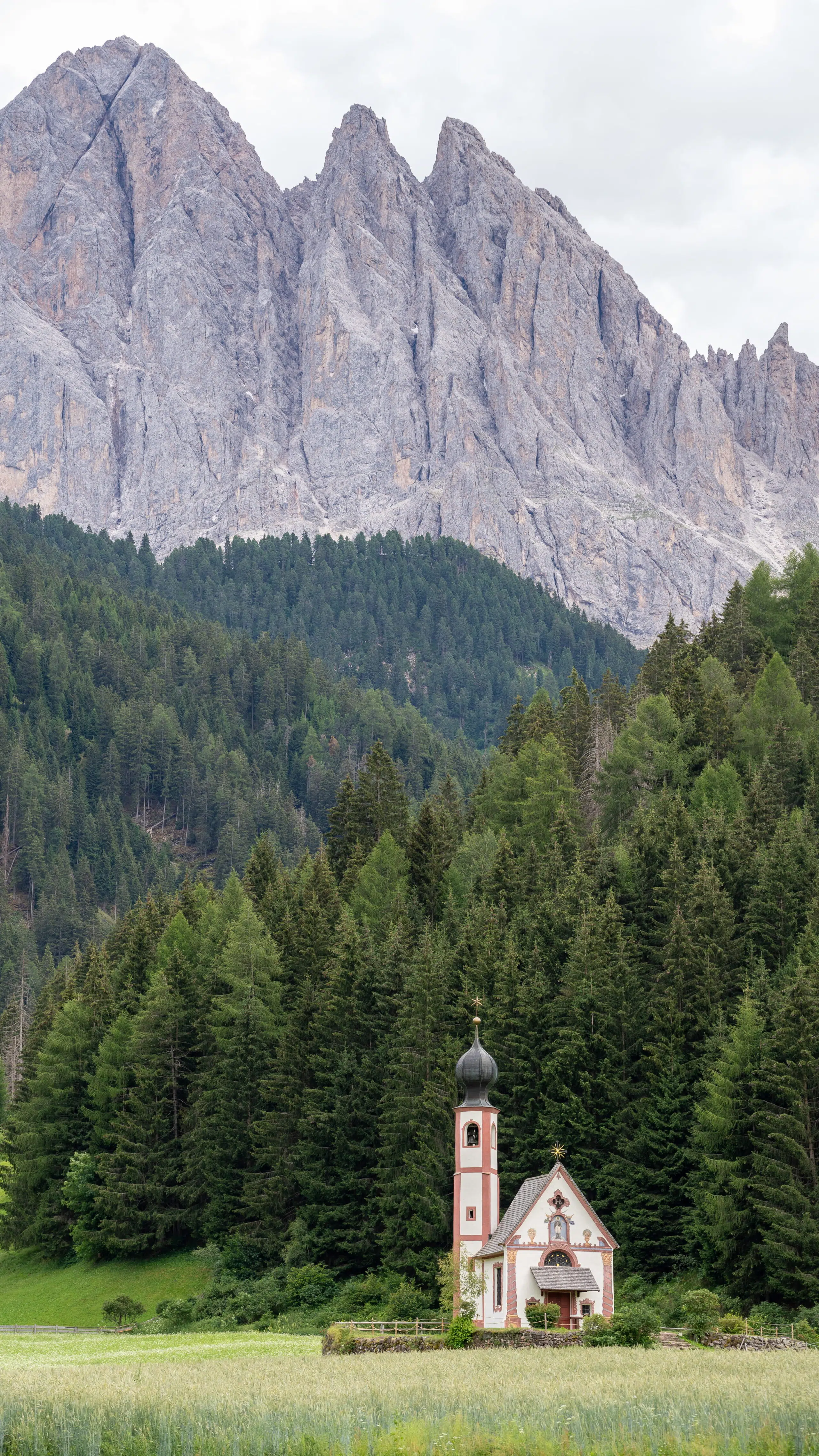 Church of St. John in Ranui with the Odle peaks behind it, Val di Funes, Dolomites
