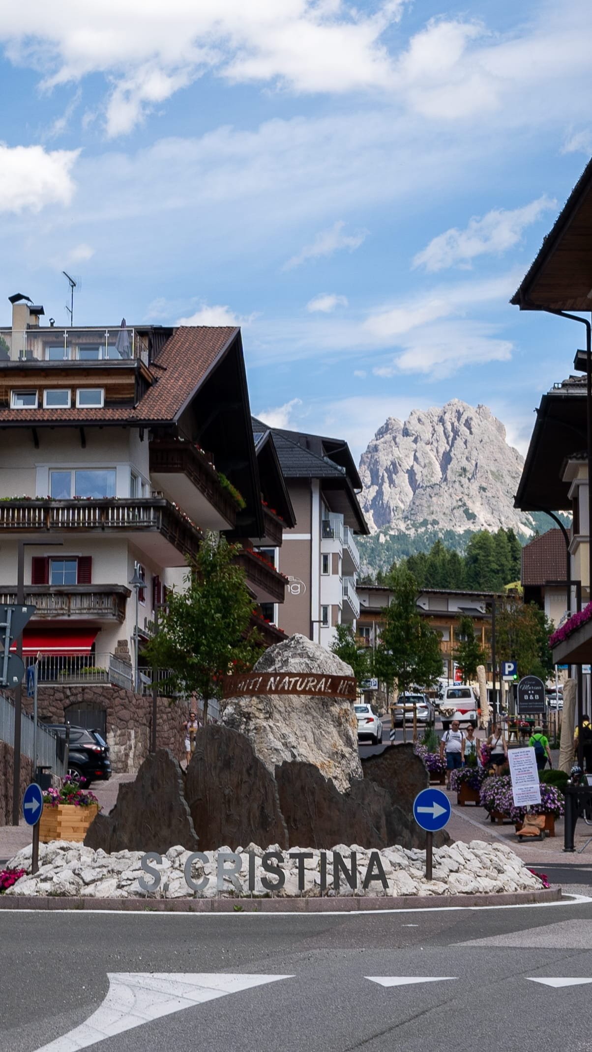 Santa Cristina village sign with Dolomites peaks in the background, Val Gardena, Italy