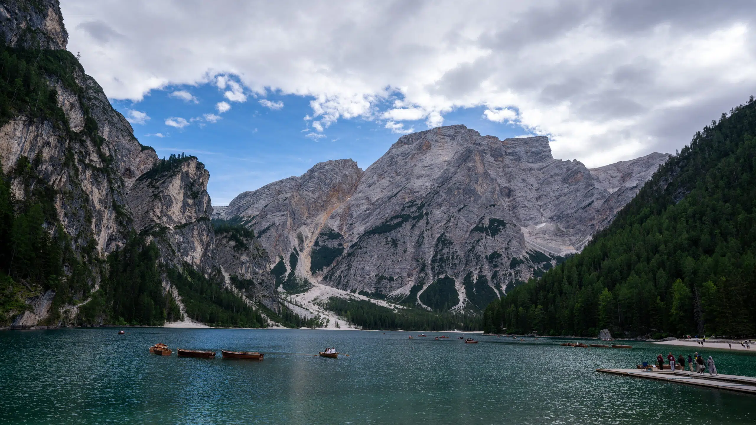 Lago di Braies worth it - the turquoise lake and wooden boathouse dock in the Dolomites