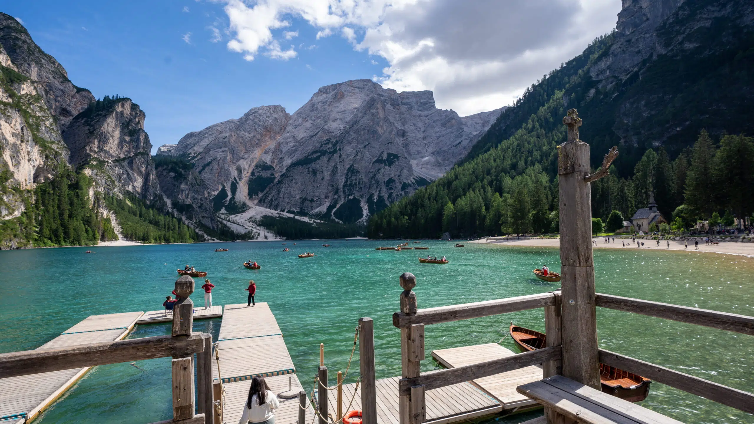 Wooden dock with carved posts and benches overlooking Lago di Braies