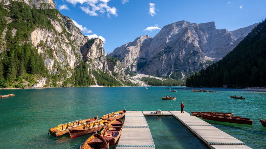 Lago di Braies worth it - turquoise water, jagged cliffs, and wooden rowboats in the Italian Dolomites