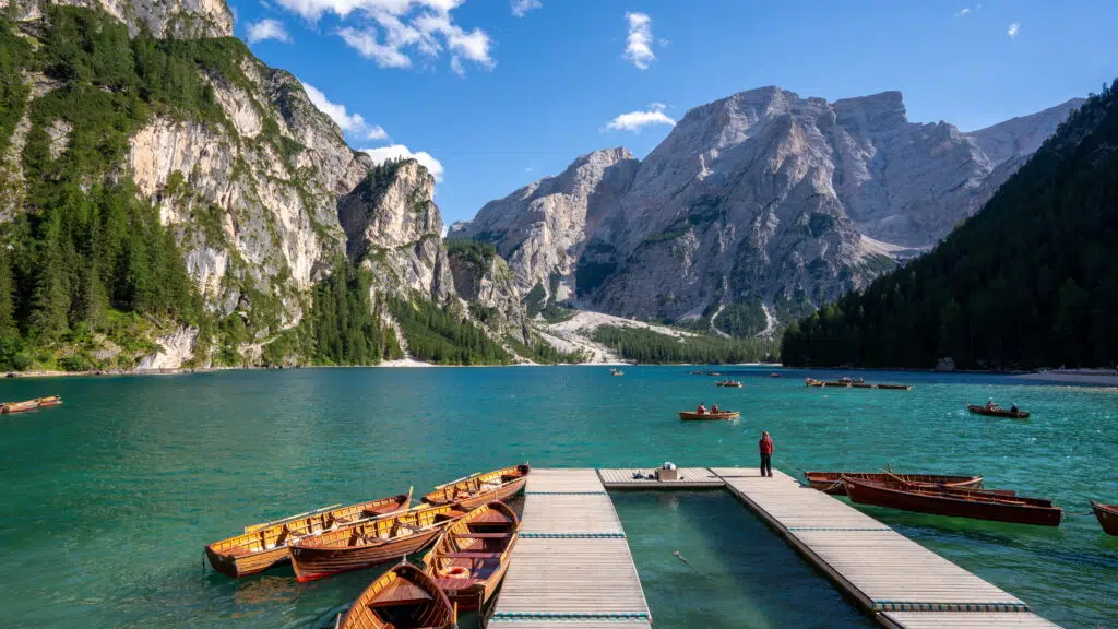 Lago di Braies worth it - turquoise water, jagged cliffs, and wooden rowboats in the Italian Dolomites