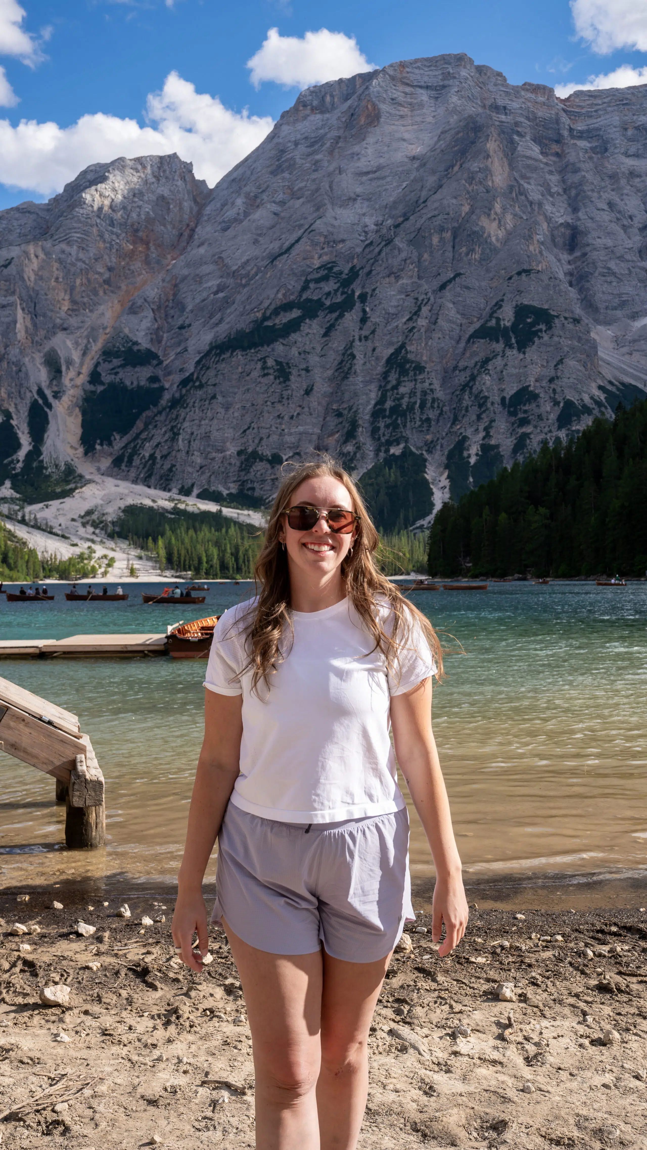 woman standing on the shore of Lago di Braies in the Dolomites