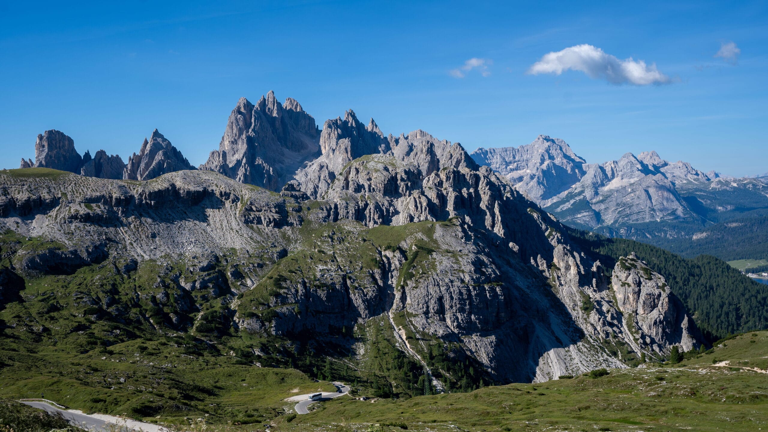 Panoramic view of jagged Dolomites peaks from a mountain pass, Italy