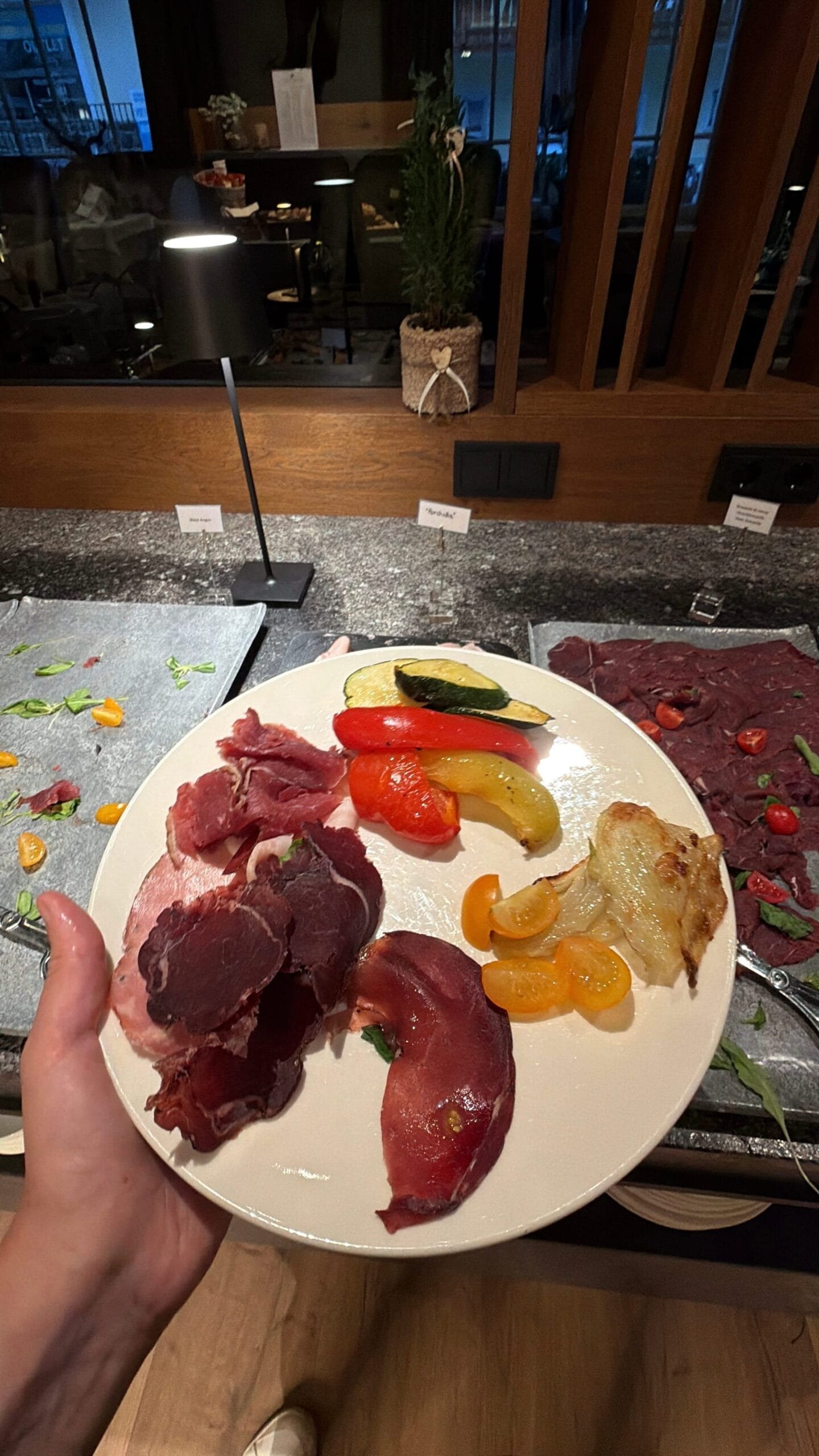 Half-board dinner spread of local cured meats and grilled vegetables at Hotel Touring, Val Gardena
