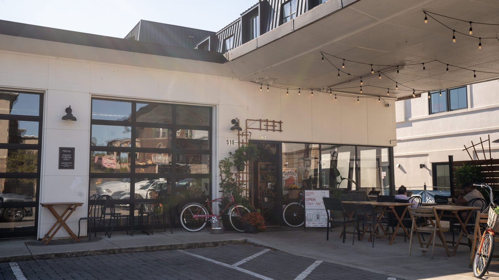 Covered outdoor patio with string lights, tables, and bikes outside a cafe in downtown Clarksville, TN