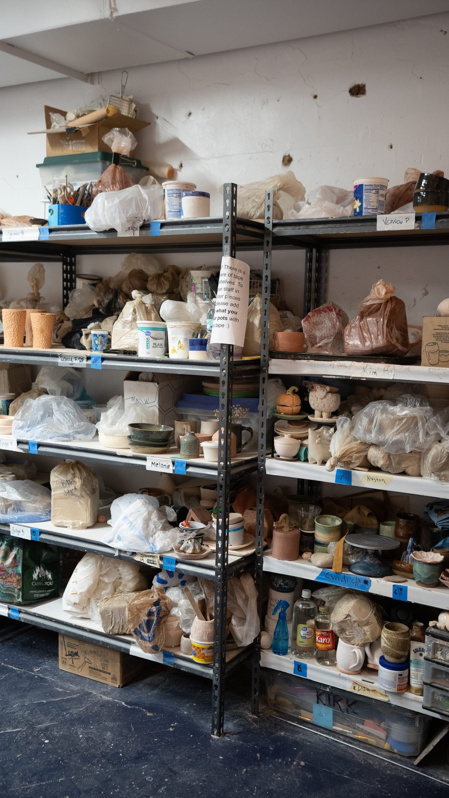 Shelves of clay, glazes, and pottery supplies inside the River City Clay studio in Clarksville, TN