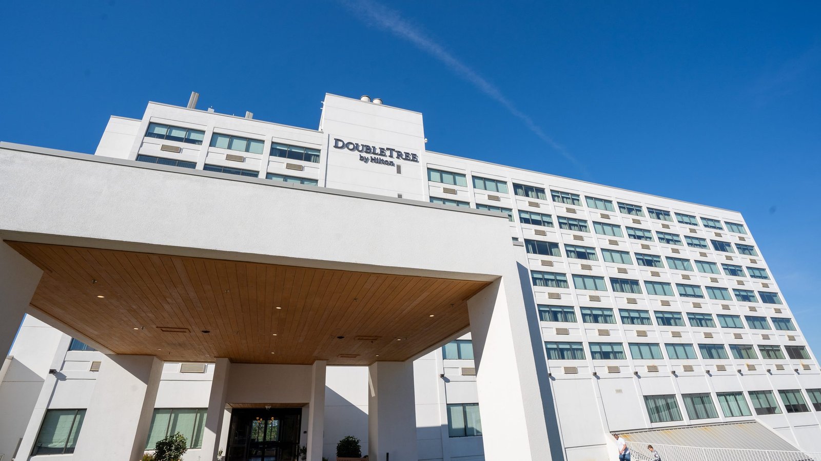 Exterior of the DoubleTree by Hilton Clarksville Downtown hotel under a bright blue sky