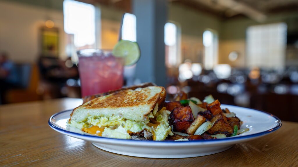 Breakfast sandwich with potatoes and a pink cherry lime agua fresca at The Mailroom in Clarksville, TN