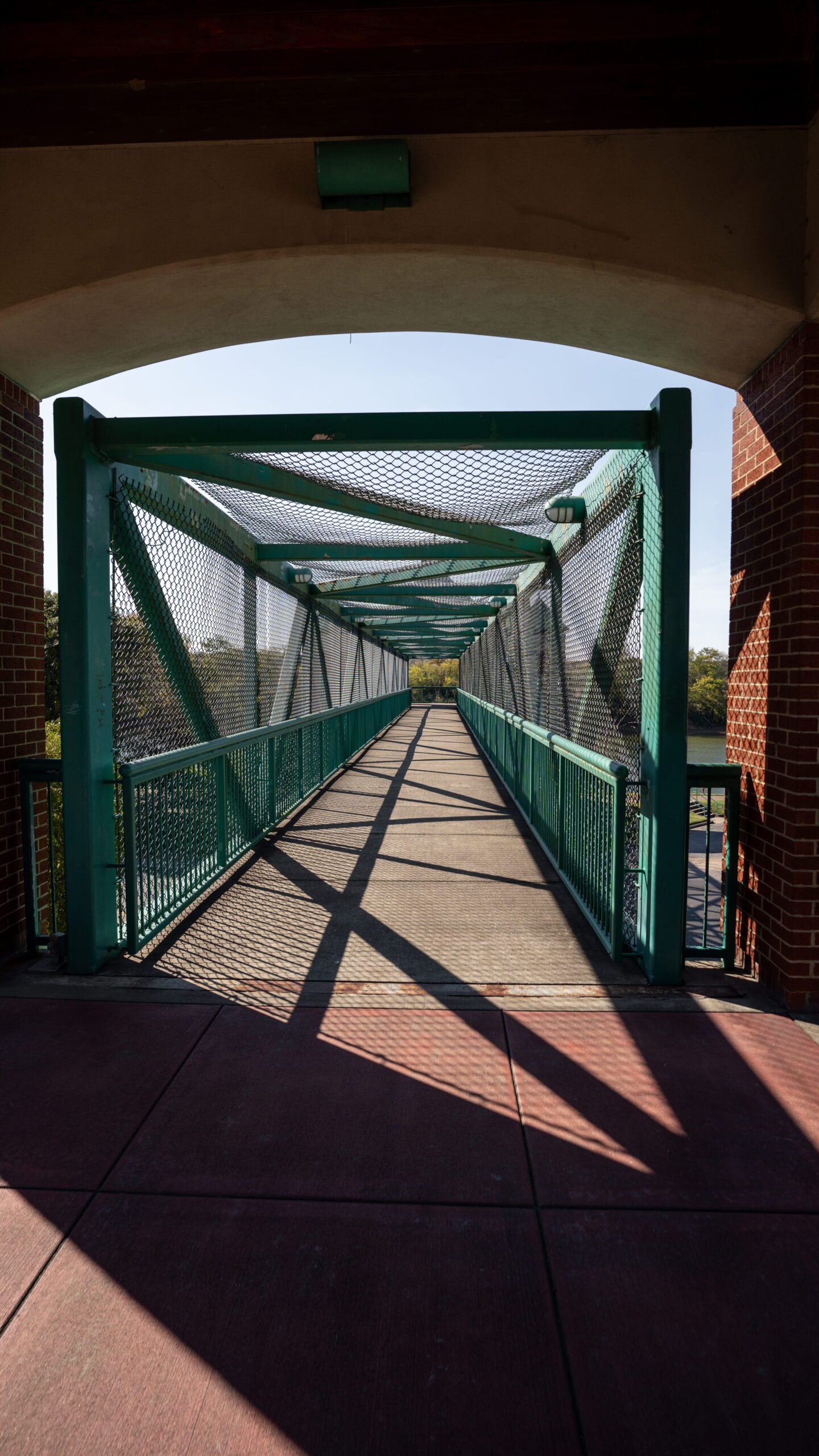 Green covered pedestrian bridge along the Cumberland Riverwalk in Clarksville, TN
