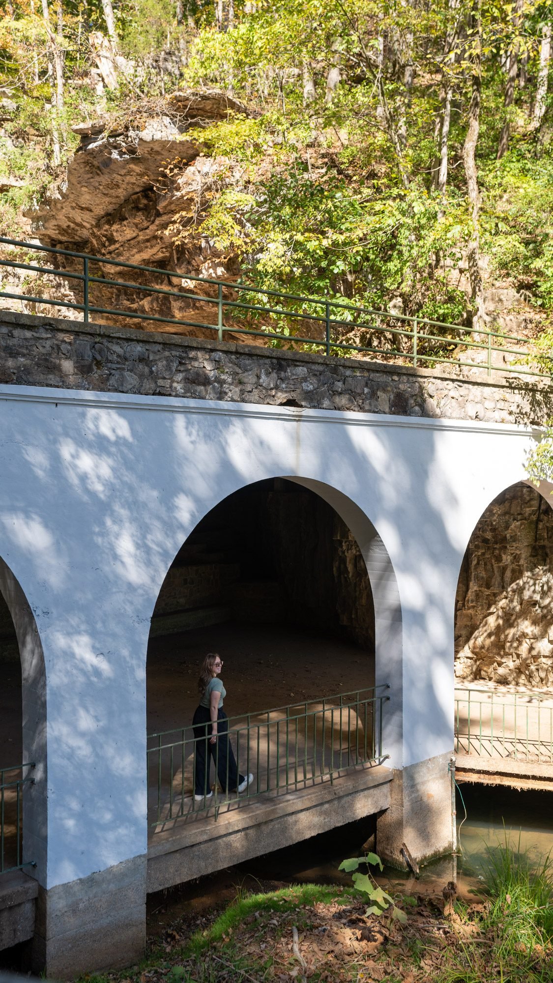 Standing under the white arches at the entrance of Dunbar Cave State Park in Clarksville, TN
