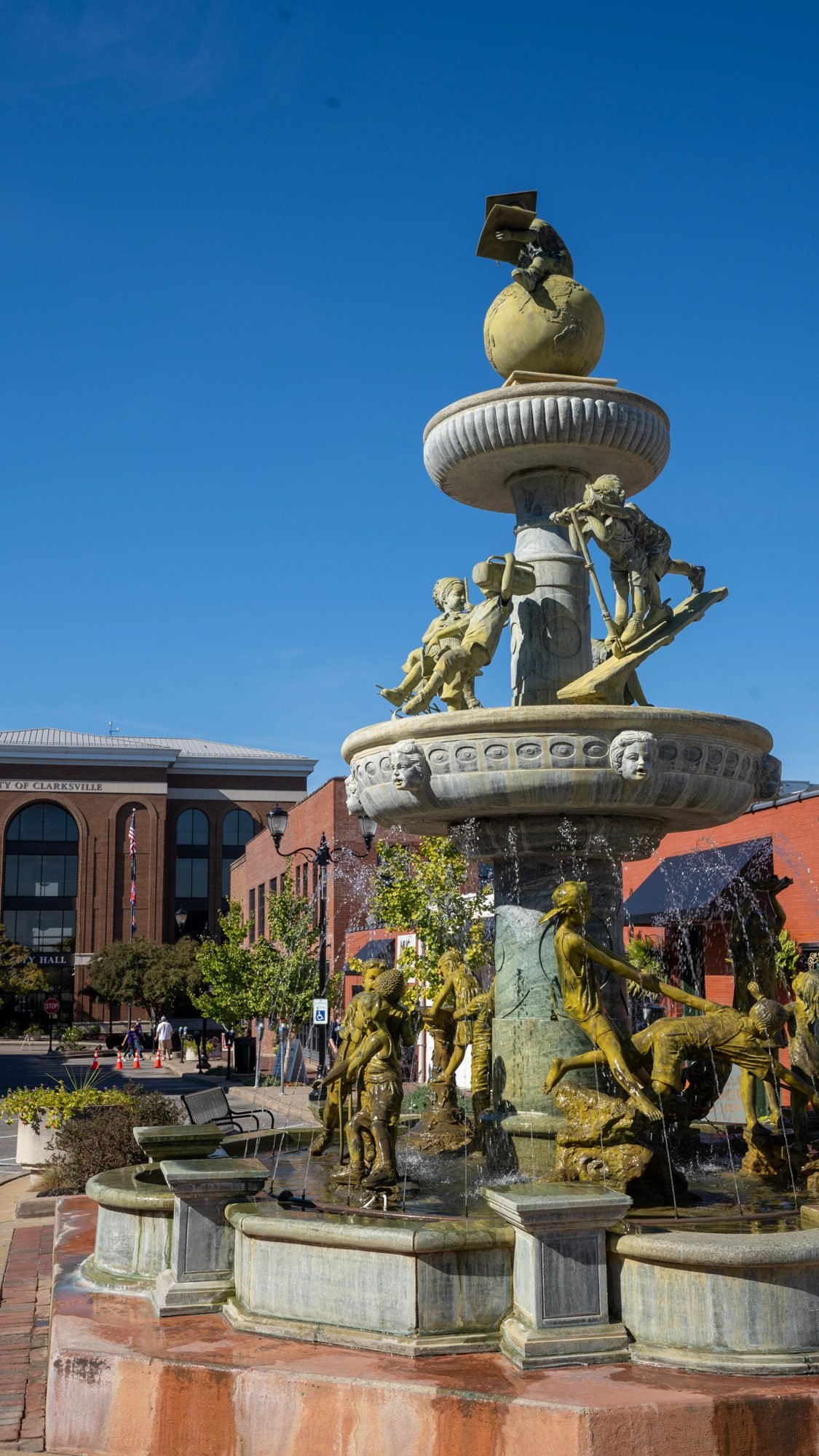 Ornate bronze fountain with sculpted figures in downtown Clarksville, TN