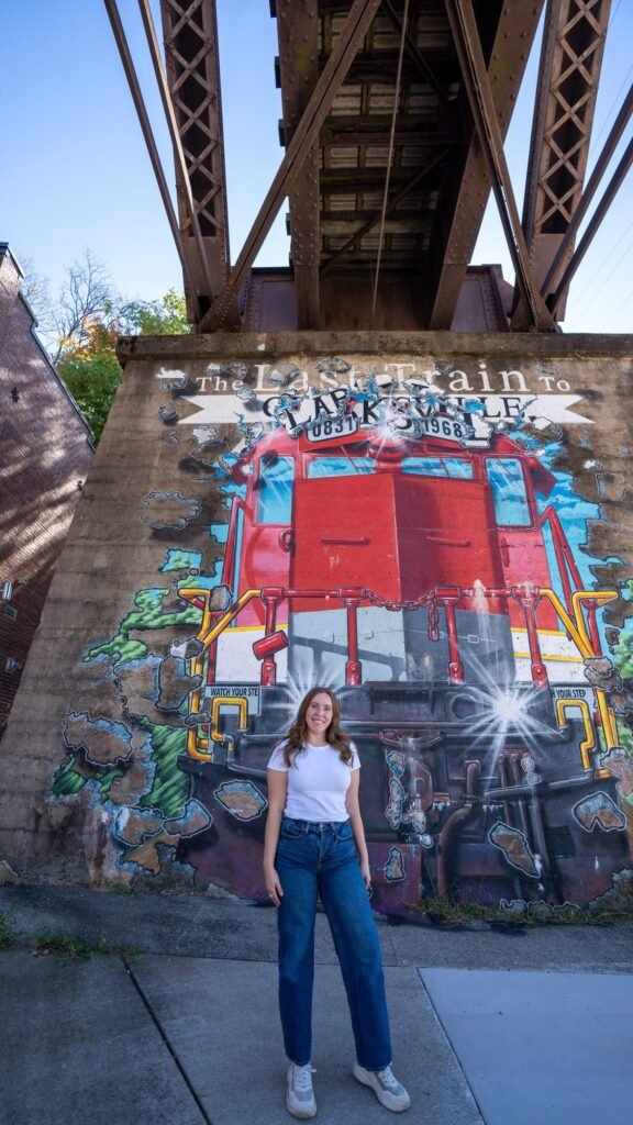 Standing in front of the Last Train to Clarksville mural under a railroad bridge in downtown Clarksville, Tennessee