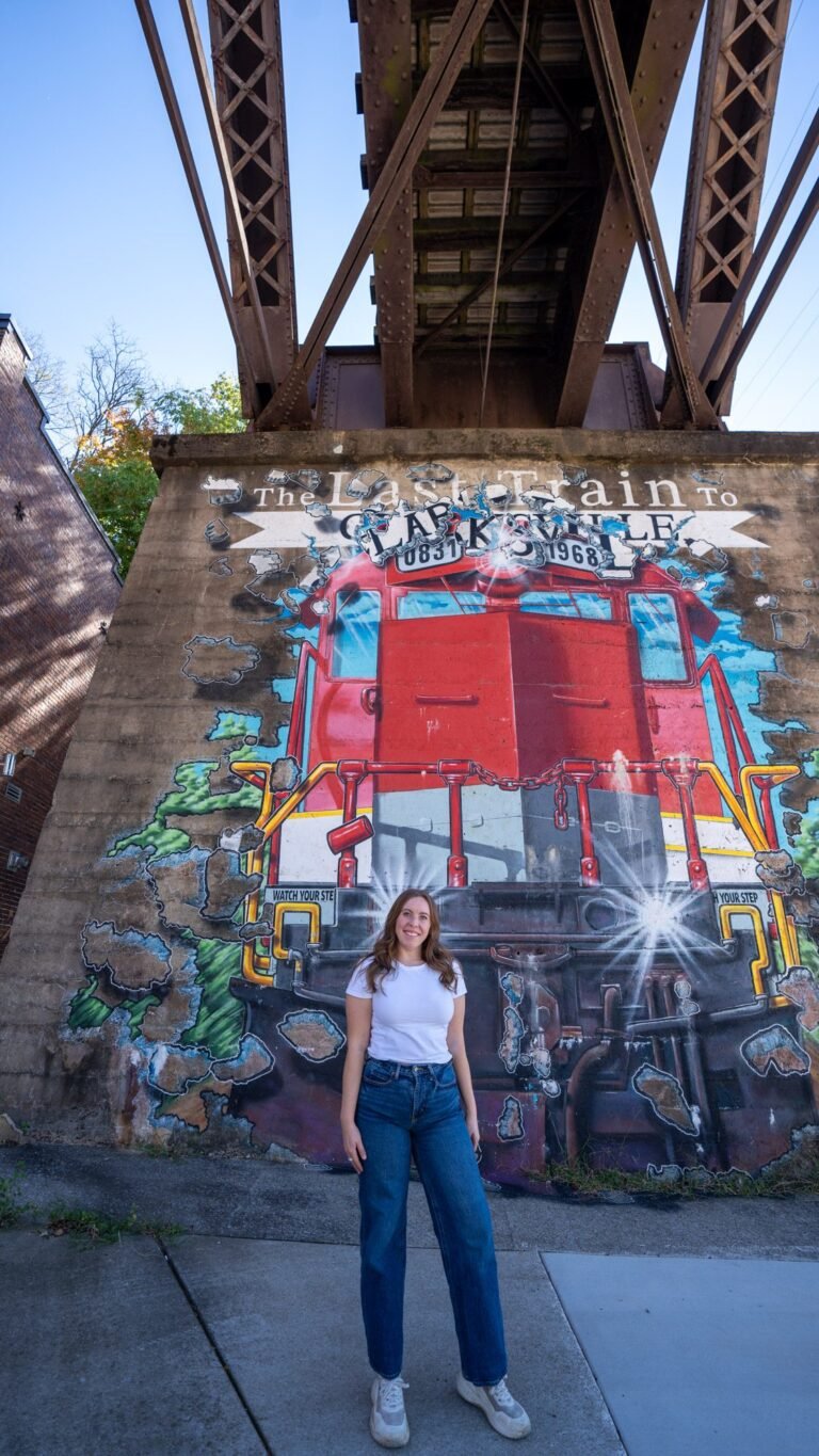 Standing in front of the Last Train to Clarksville mural under a railroad bridge in downtown Clarksville, Tennessee